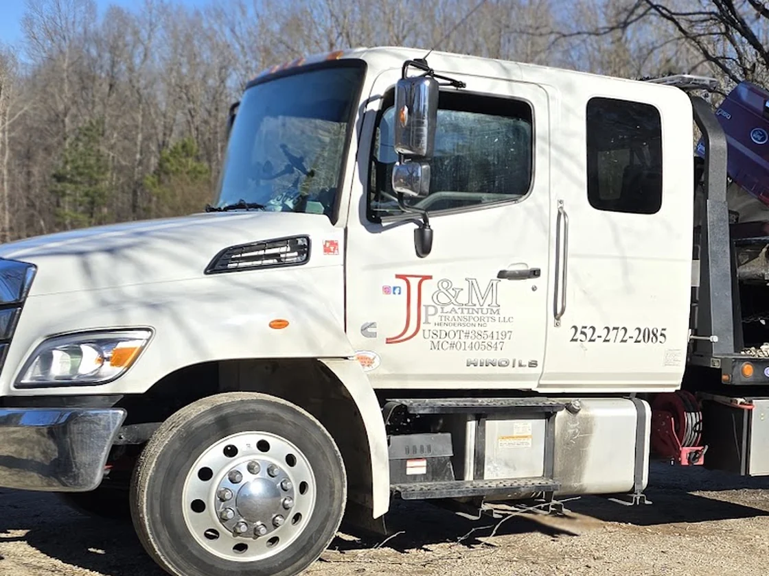 The cab of the J&M Platinum Transports white Hino rollback tow truck